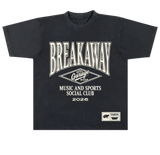 A black short-sleeve t-shirt with a vintage-style cream graphic print on the front. The graphic features the text 'BREAKAWAY' in a large arched font, a diamond logo reading 'Garage Beer', and 'MUSIC AND SPORTS SOCIAL CLUB 2026'.