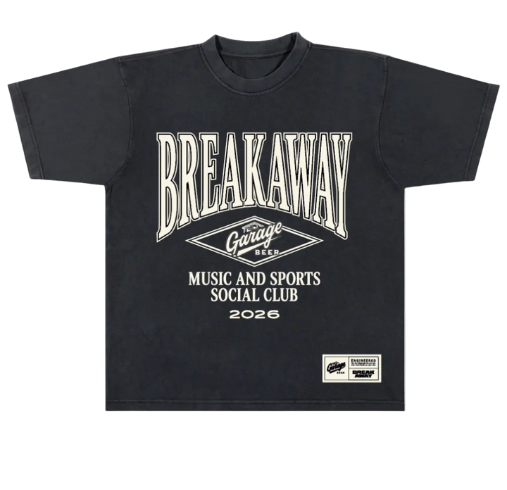 A black short-sleeve t-shirt with a vintage-style cream graphic print on the front. The graphic features the text 'BREAKAWAY' in a large arched font, a diamond logo reading 'Garage Beer', and 'MUSIC AND SPORTS SOCIAL CLUB 2026'.